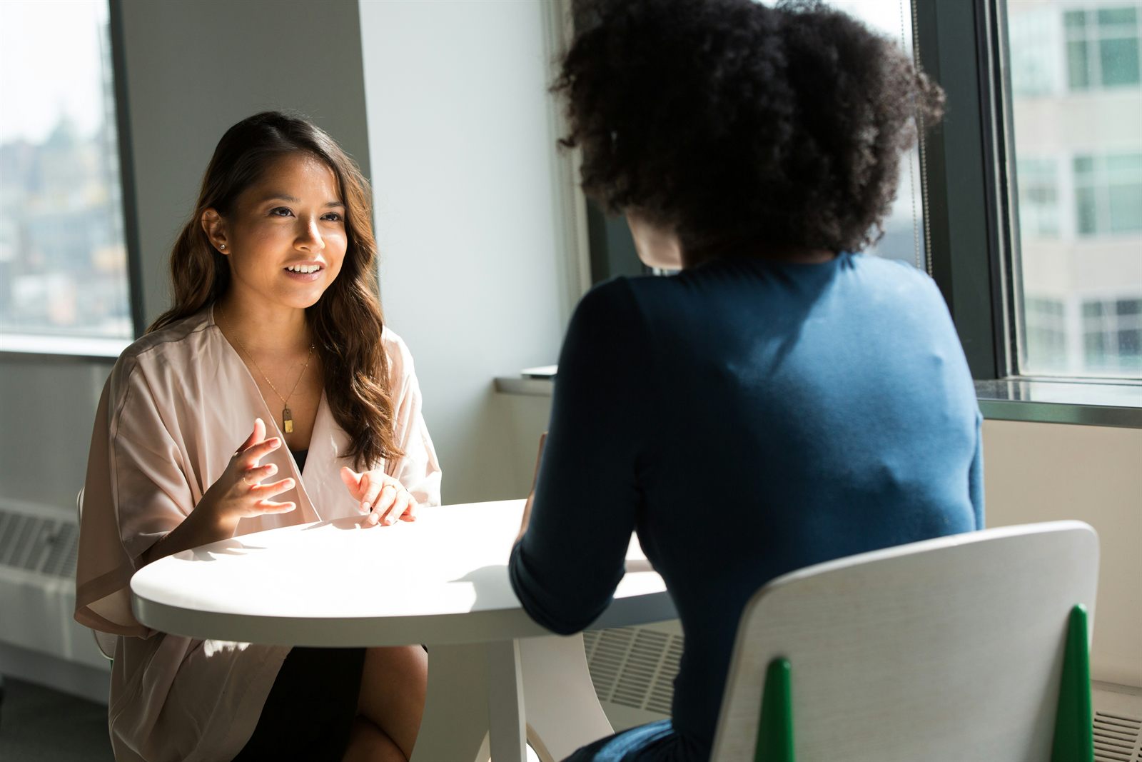 Two social work professionals collaborating during a one-on-one conversation